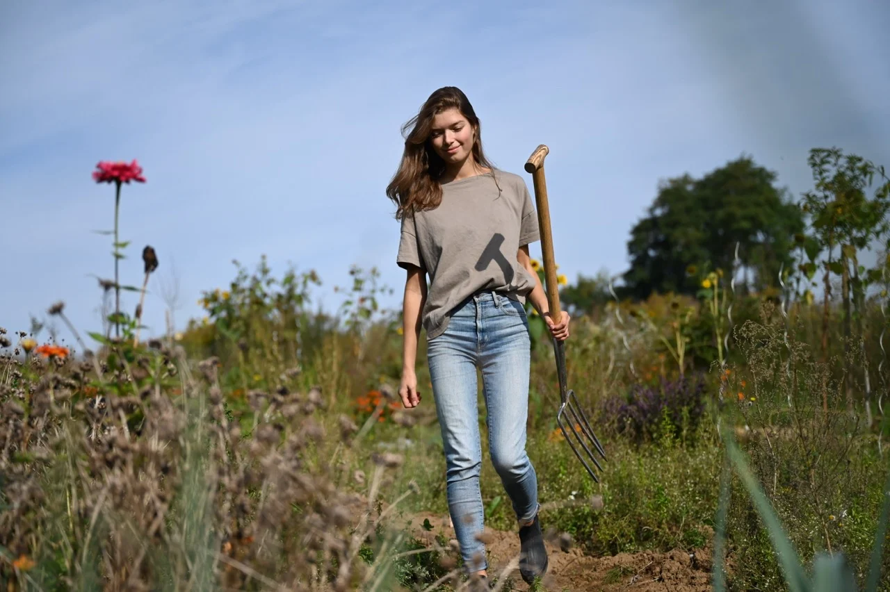 Gardener in the garden with digging fork